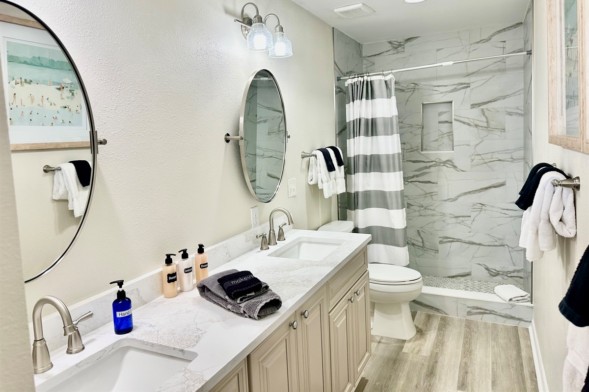 Newly renovated master bath with a double vanity and walk-in shower.