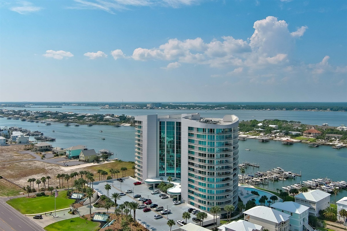 A serene marina scene unfolds, with the vast expanse of the Gulf of Mexico providing a breathtaking backdrop. The gentle rhythm of the bay meets the boundless energy of the open sea.