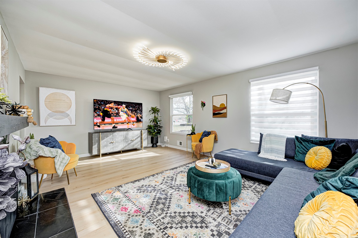 Spacious second living room perfect for movie nights and game days — kick back on the oversized sectional while the whole crew relaxes together