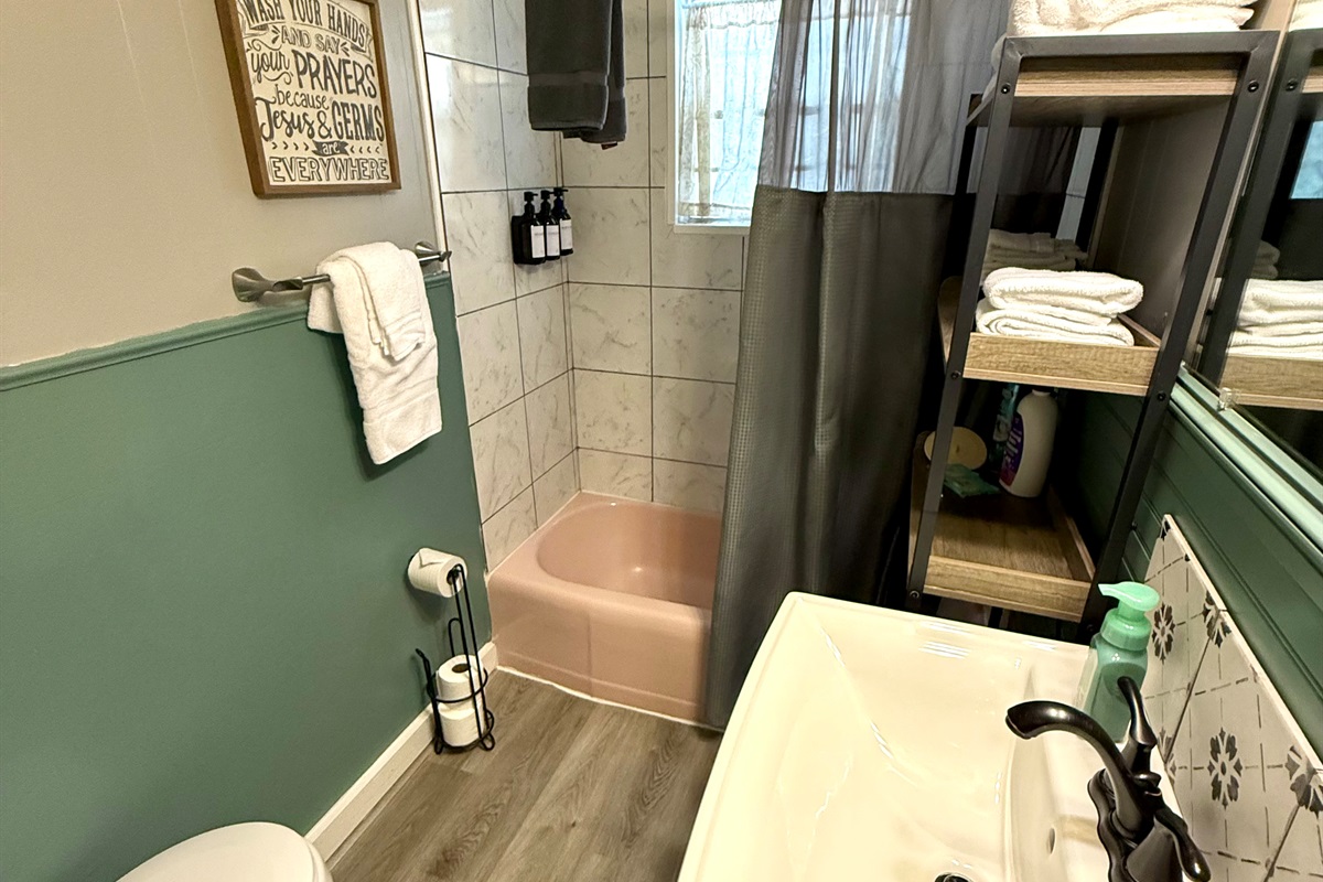 Full bath with tub/shower combo.