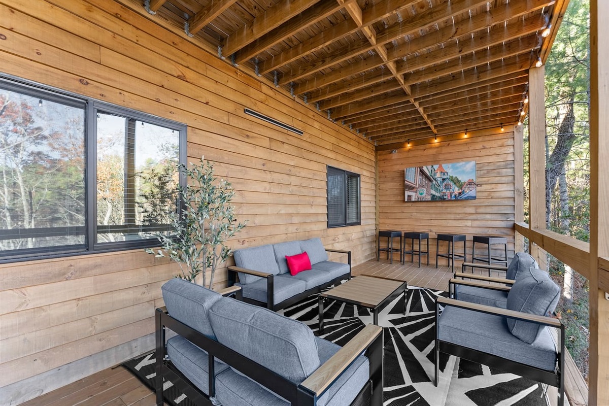 Spacious outdoor seating area with a TV