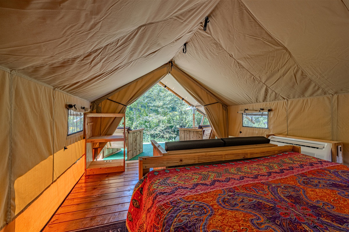 Your peaceful hideaway. The warm lighting and colorful bedding make this tent a true sanctuary. Glimpse the forest through your window screen while you settle in for the night.