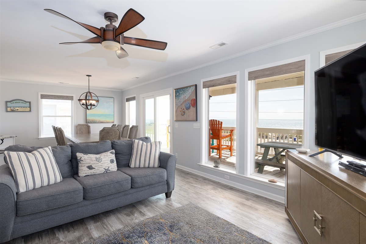 Ceiling fan gently spinning, endless ocean view outside
