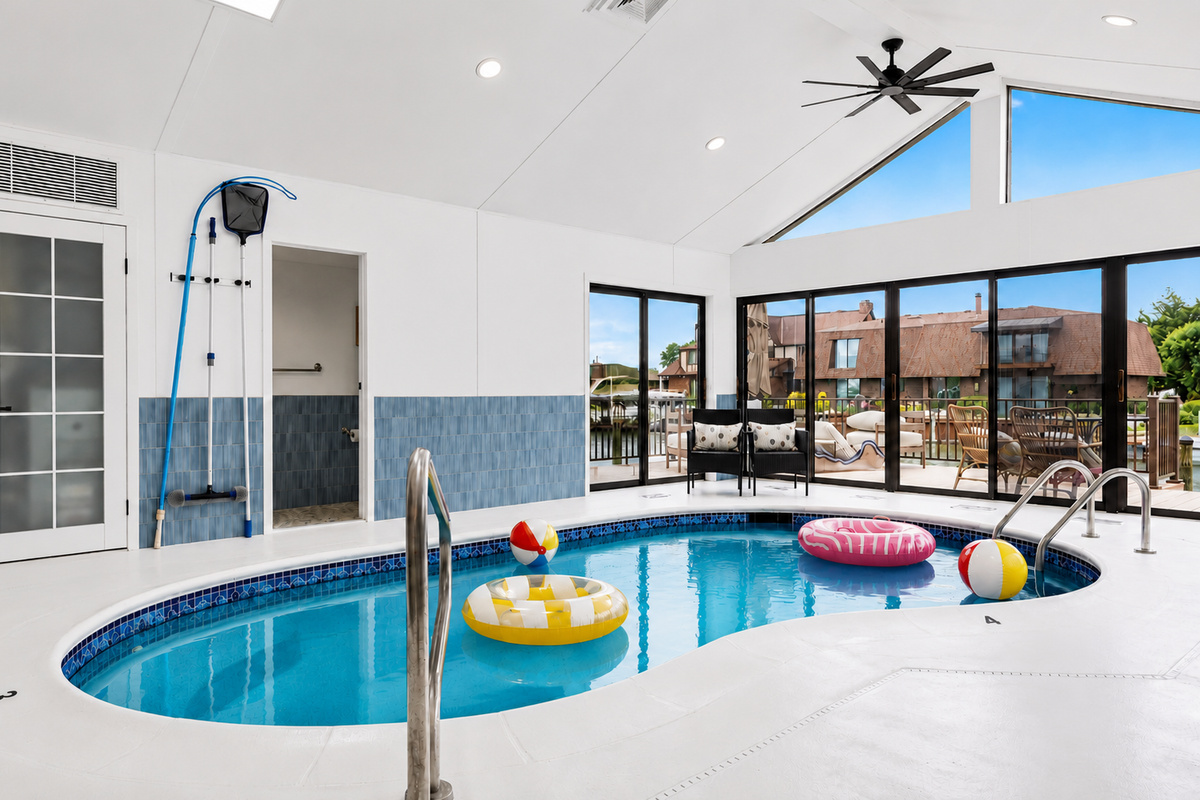 Relax and enjoy year-round swimming in this bright indoor heated pool, featuring vaulted ceilings, skylights, and a spacious open design ideal for both lounging and entertaining.
