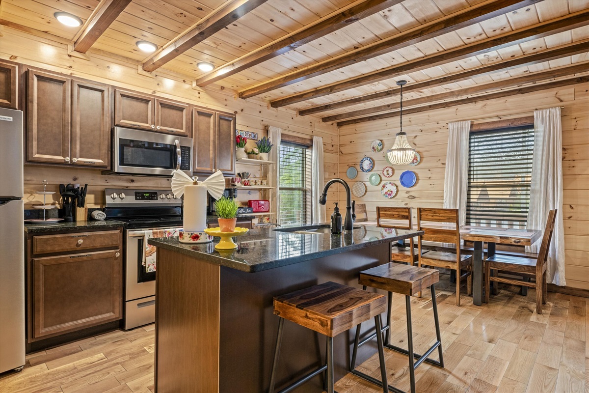 The kitchen has an island (fits 2) and a dining table (fits 8)