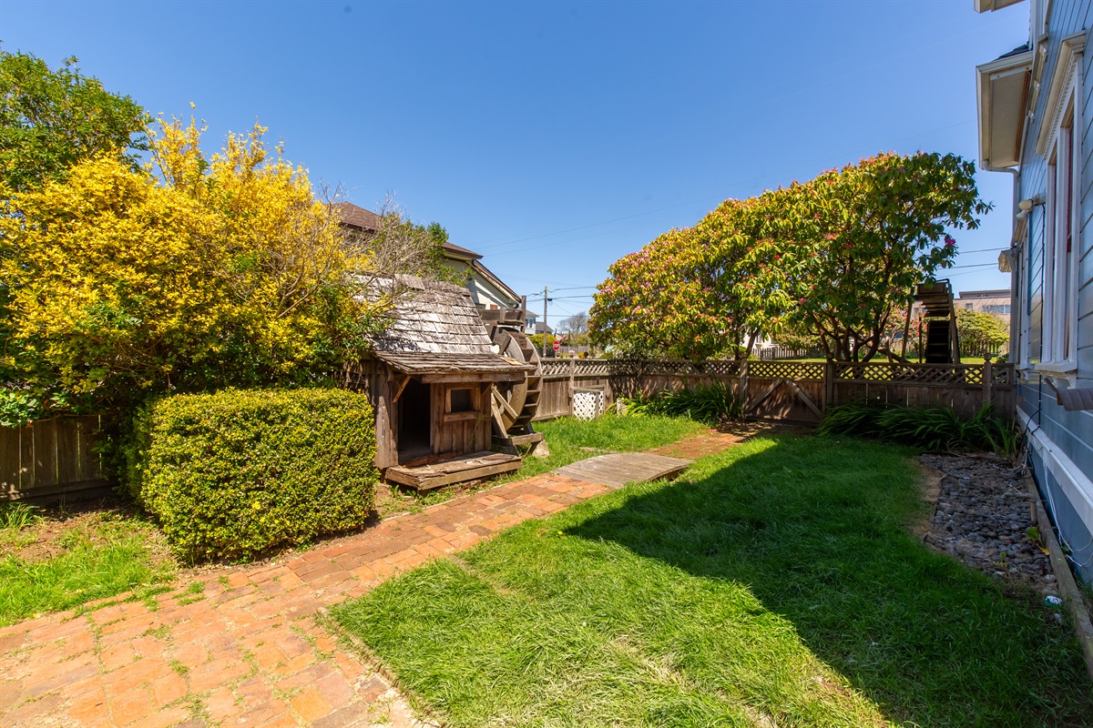 Enclosed backyard with green lawn and fencing