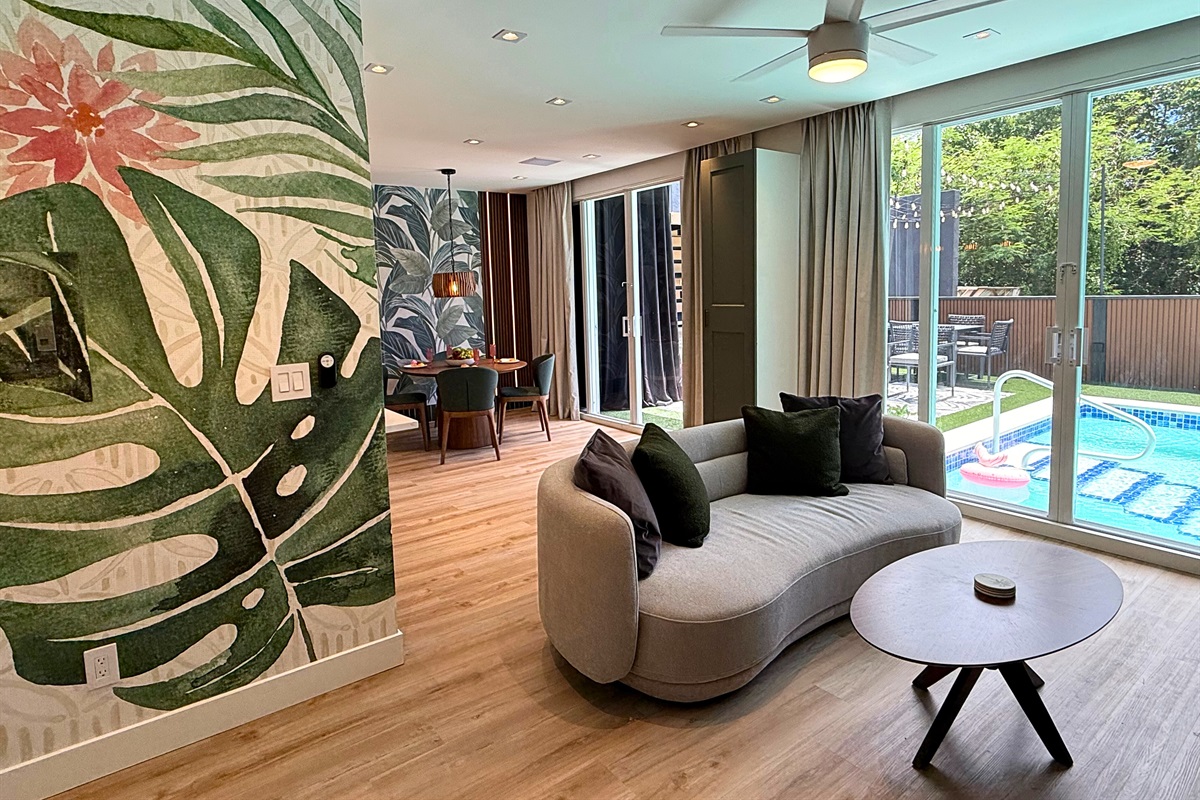 Living room has sliding doors that lead to the private pool