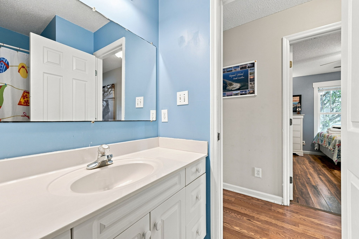 Bright vanity area with generous counter space, perfect for getting ready after a day at the beach