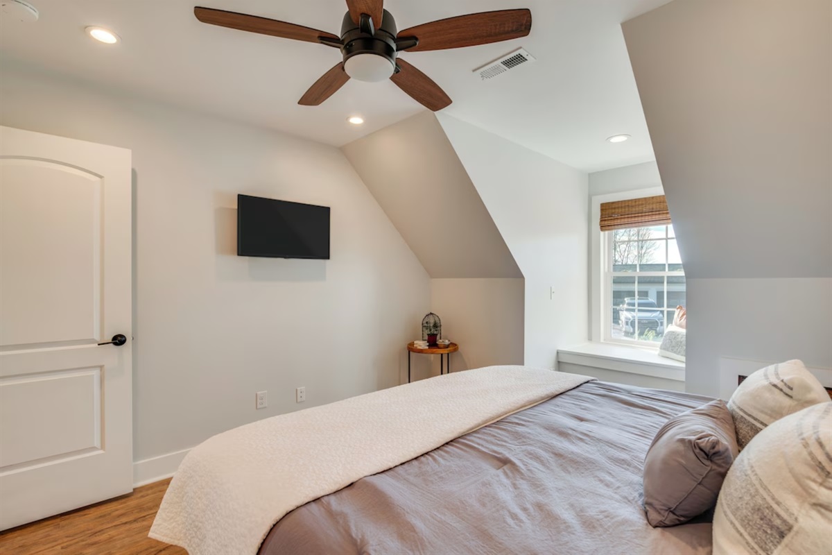 Bedroom with ceiling fan and king bed