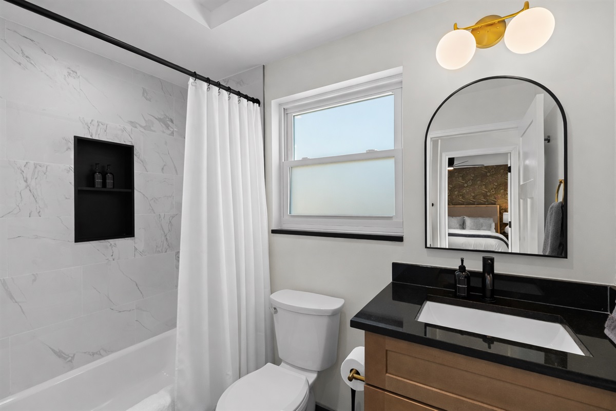 Bright, modern bathroom with a sleek vanity, spa-like shower, and soft natural light—designed for a refreshing and comfortable stay.