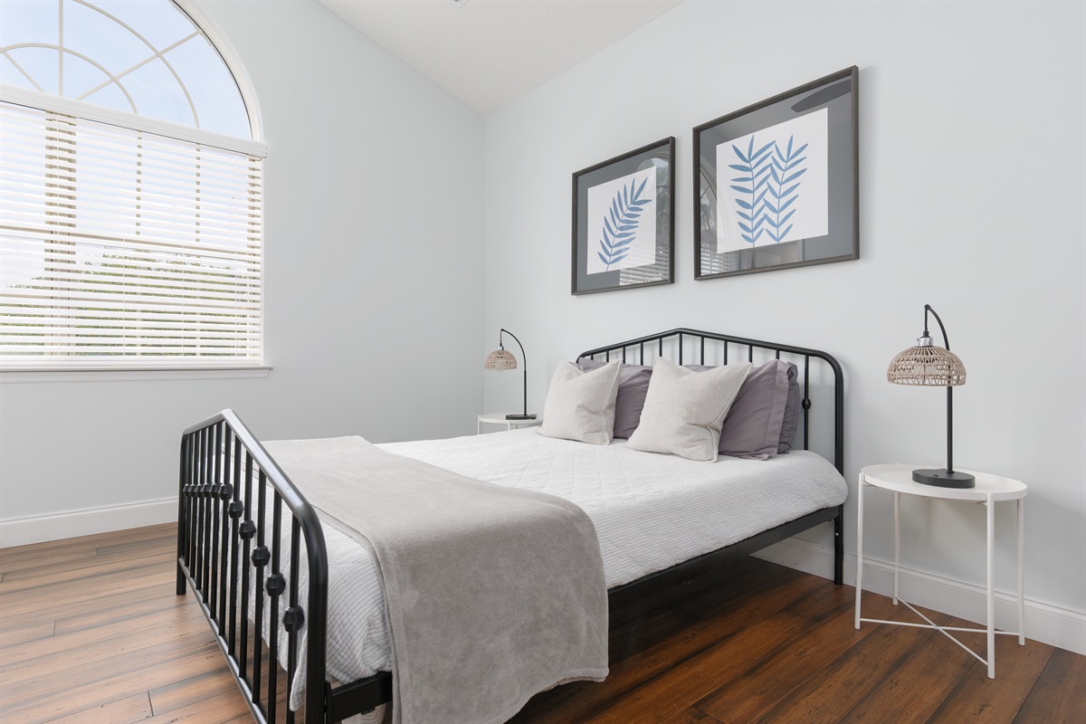 Crisp linens and natural light make this guest room a cozy escape