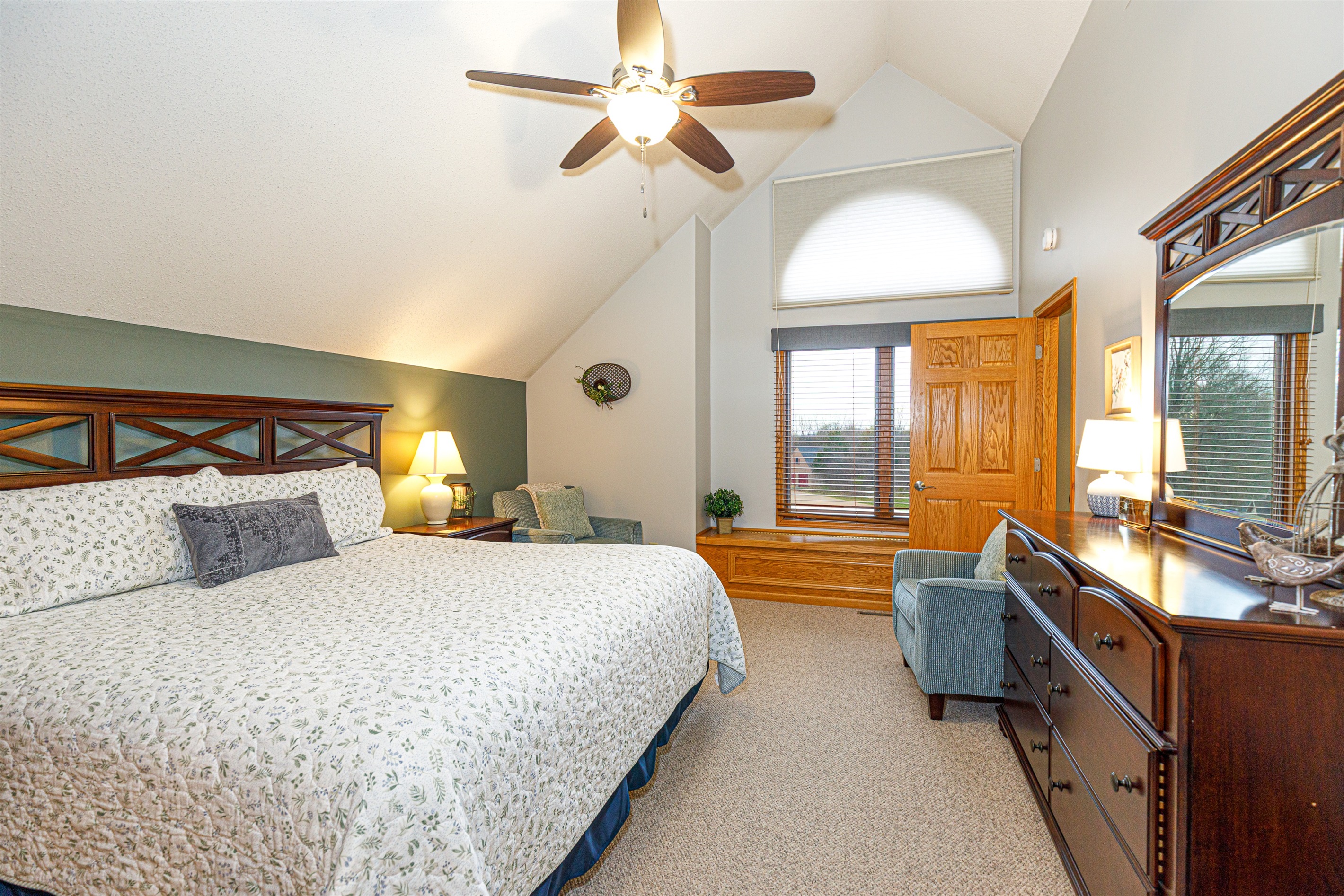 Large primary suite with a king bed, sitting area, and ensuite bathroom