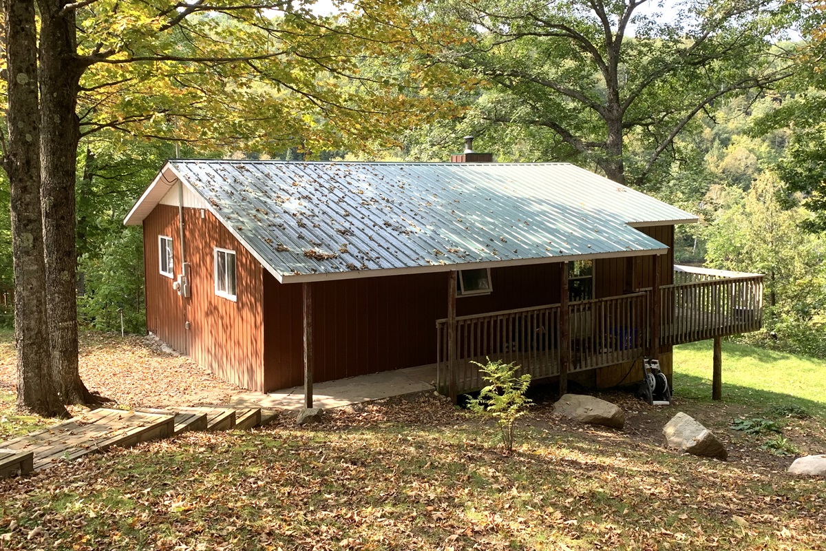 Sheltered under mature sugar maples, this is a view of cottage from driveway