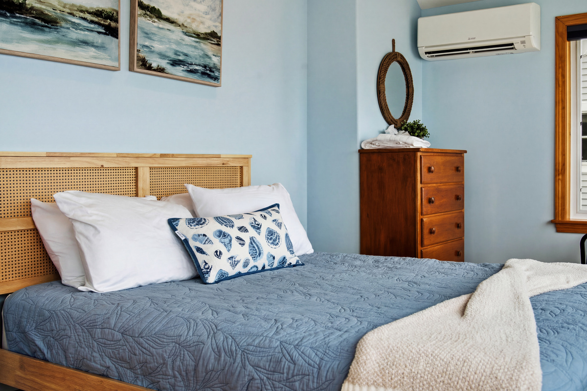 Comfortable queen bedroom with coastal décor and a peaceful atmosphere.
