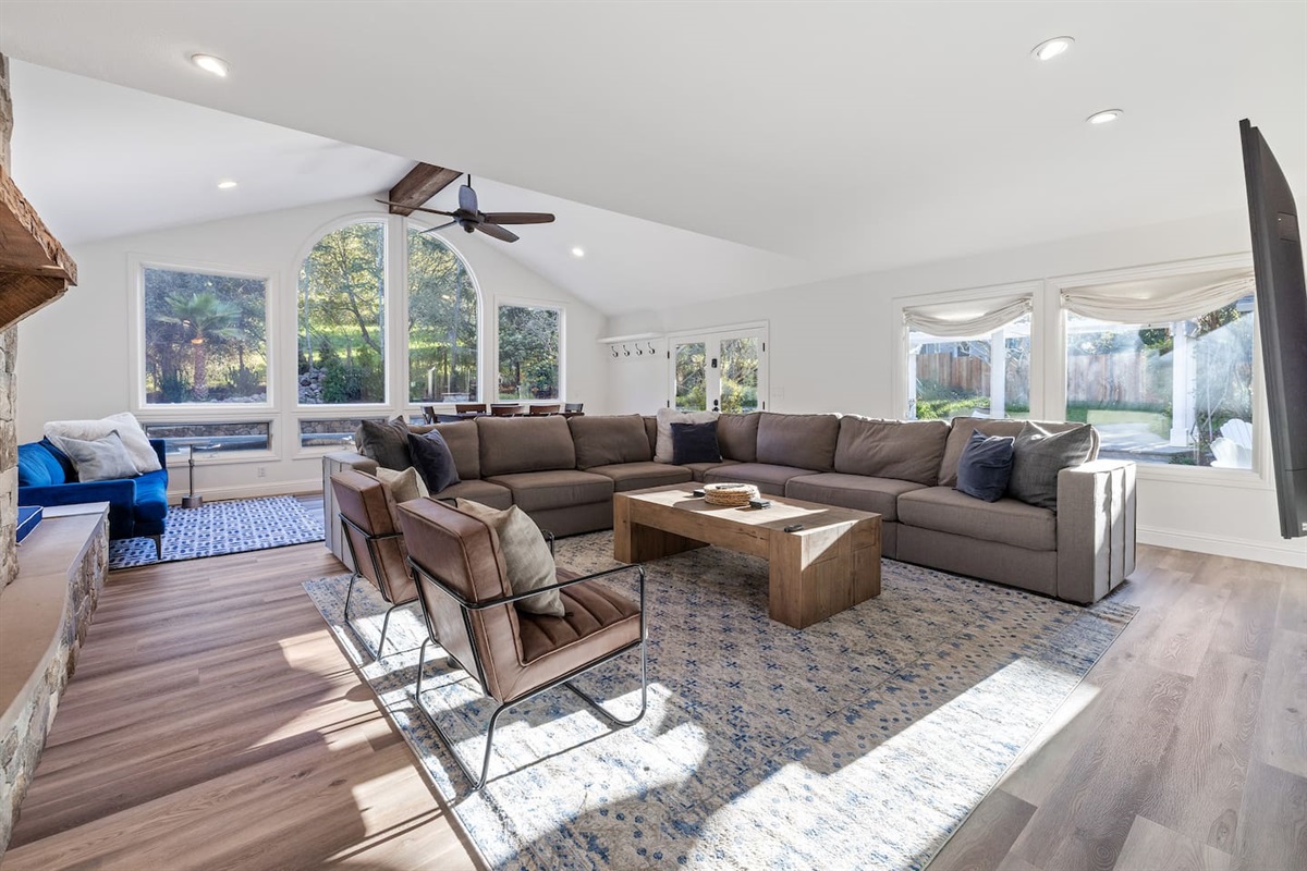 Next to the fireplace, a blue couch and window seat in the great room. The blue couch will is a Pottery Barn queen-sized sleeper sofa. A full set of queen linens are provided for guest use.