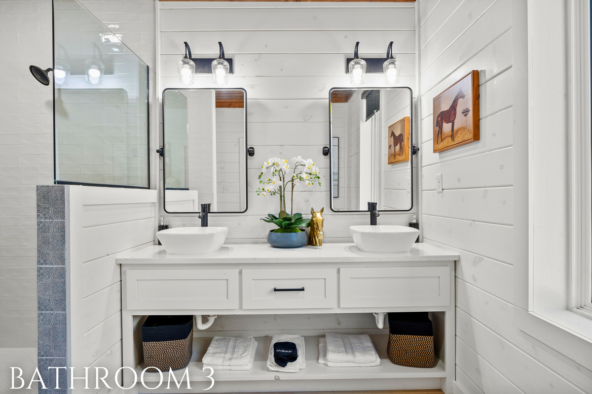 A crisp and clean ensuite featuring soft lighting, a spacious vanity, and plenty of room to unwind.
