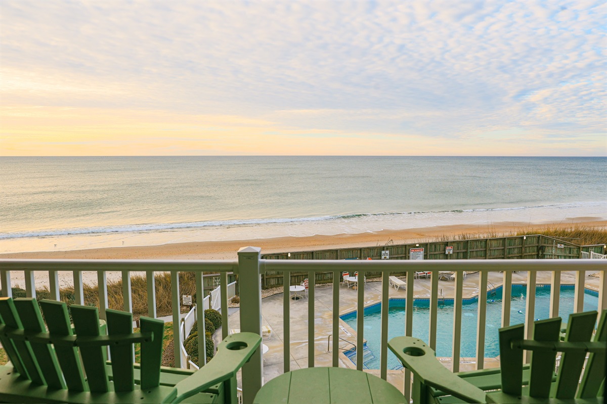 Coastal paradise: a balcony with beach and pool views.
