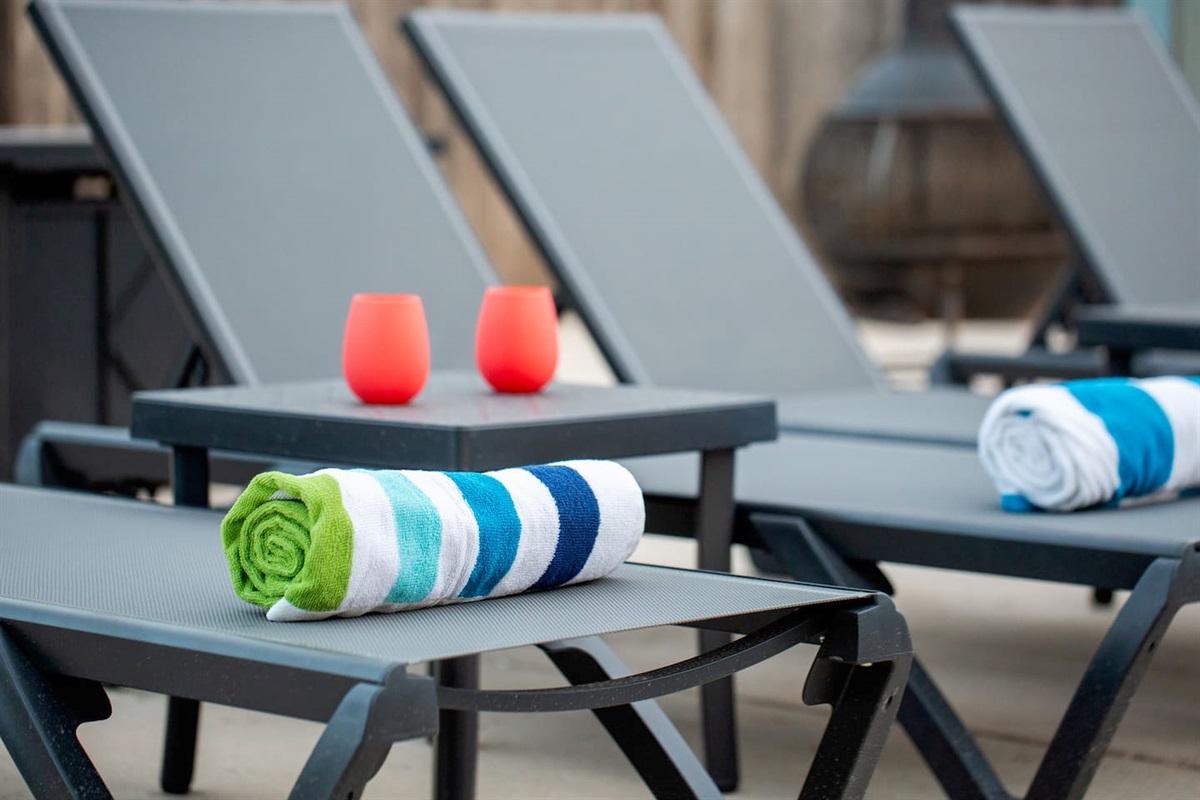 Our poolside lounge area is ready for your day of sunbathing or an evening of stargazing, complete with comfortable loungers, colorful towels, and silicone glasses to enjoy your drinks in.