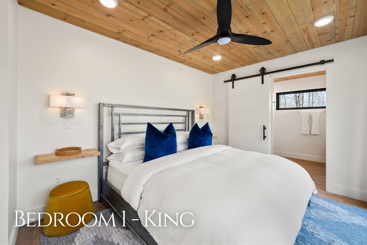This king bedroom offers a calm and restful retreat, with warm wood ceilings, soft lighting, and a comfortable bed that makes it easy to unwind.