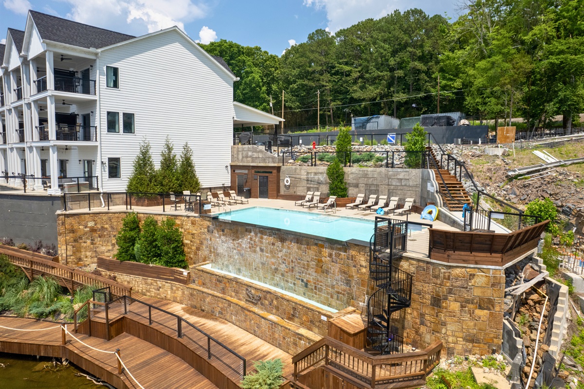 Lakefront pool area with direct water access and lounge chairs.