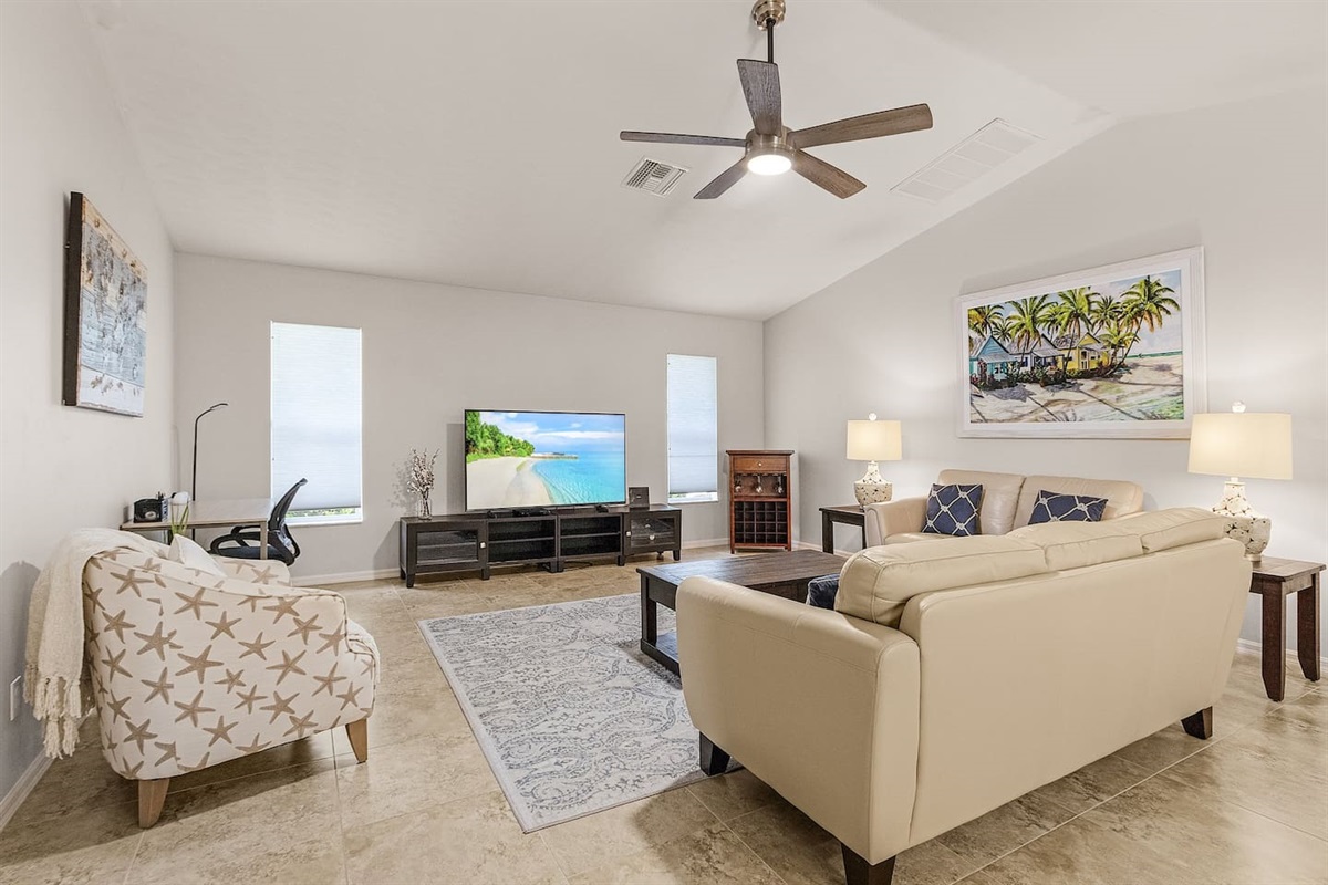 Open-concept living space with a large TV, ideal for entertaining or relaxing!