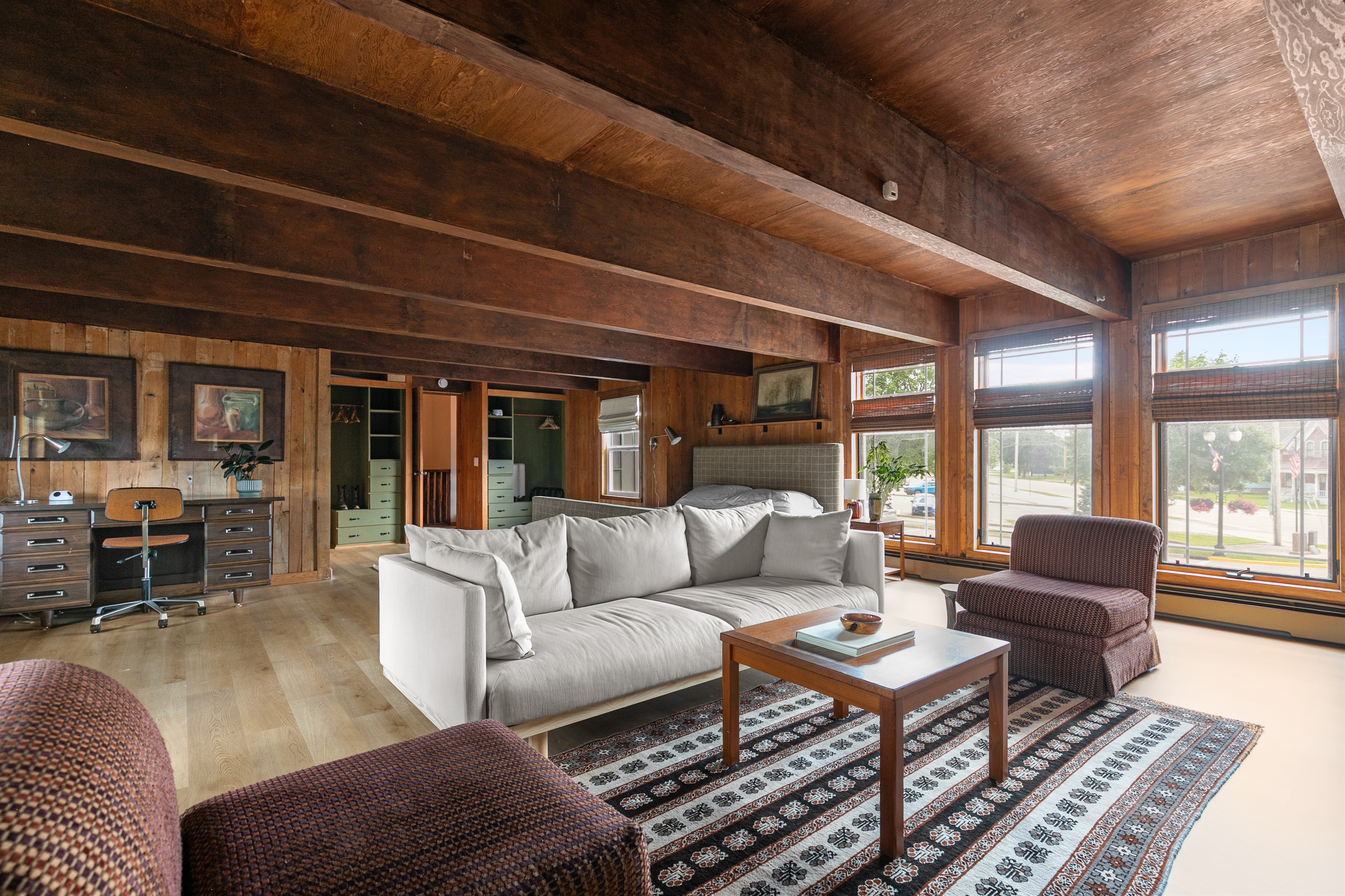 The primary bedroom is filled with windows, letting natural sunlight pour in during the day. Prefer to sleep in? Simply close the coverings for a dark, restful morning retreat.