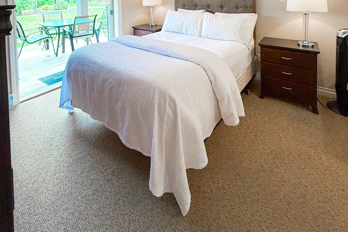 Unit A Primary Queen Bed - Double glass Patio doors.