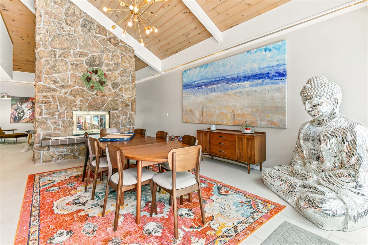 The dining area comfortably seats nine guests, featuring an expandable table and a two-sided fireplace. Its proximity to the fully equipped kitchen, Living Room 1, and the Back Patio adds convenience to mealtimes and social gatherings.