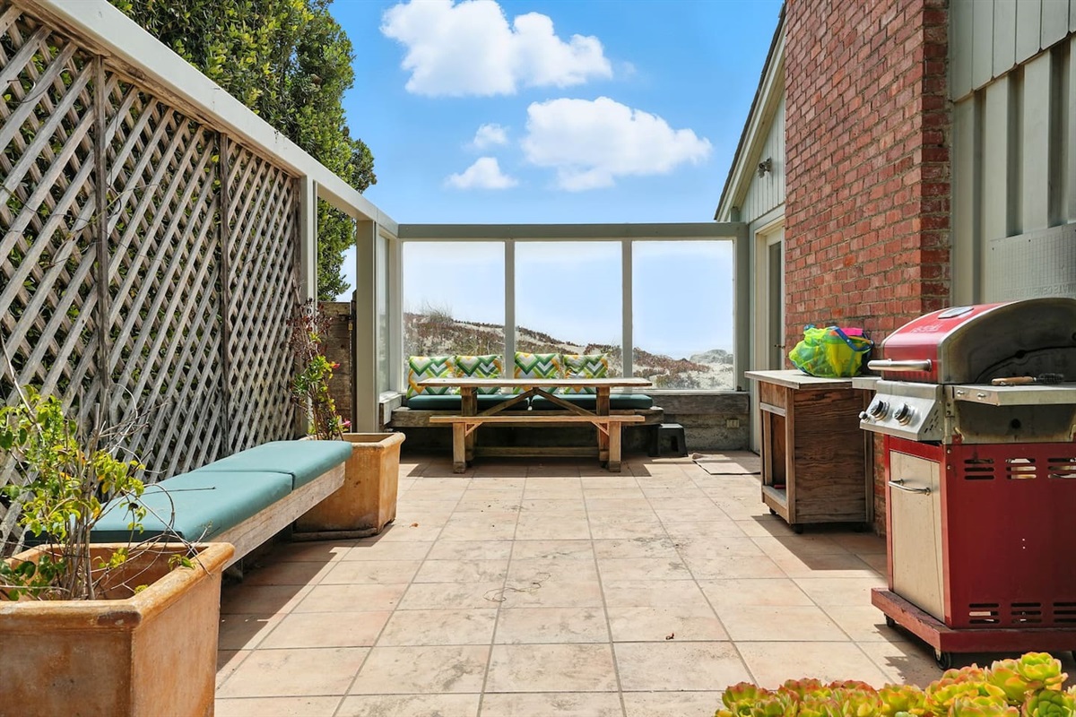 - Spacious patio with BBQ grill, built in benches, and shaded lounge area  
- Enclosed design offers privacy while still enjoying ocean views nearby  
- Great for outdoor meals, family gatherings, or relaxed afternoons  