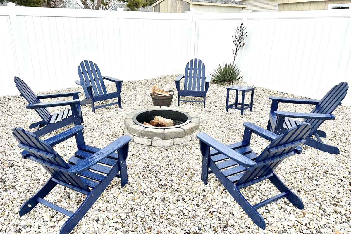 Gather around our stone fire pit for the ultimate evening under the stars. With six comfortable blue Adirondack chairs set on a tidy gravel base and enclosed by a privacy fence, it’s the perfect spot for roasting marshmallows and making memories.
