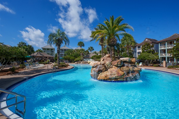 Resort-style lagoon pool with waterfall feature and tropical landscaping