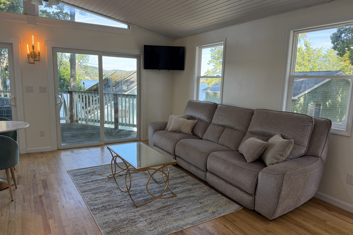 Living room with sliders to deck and SmartTV