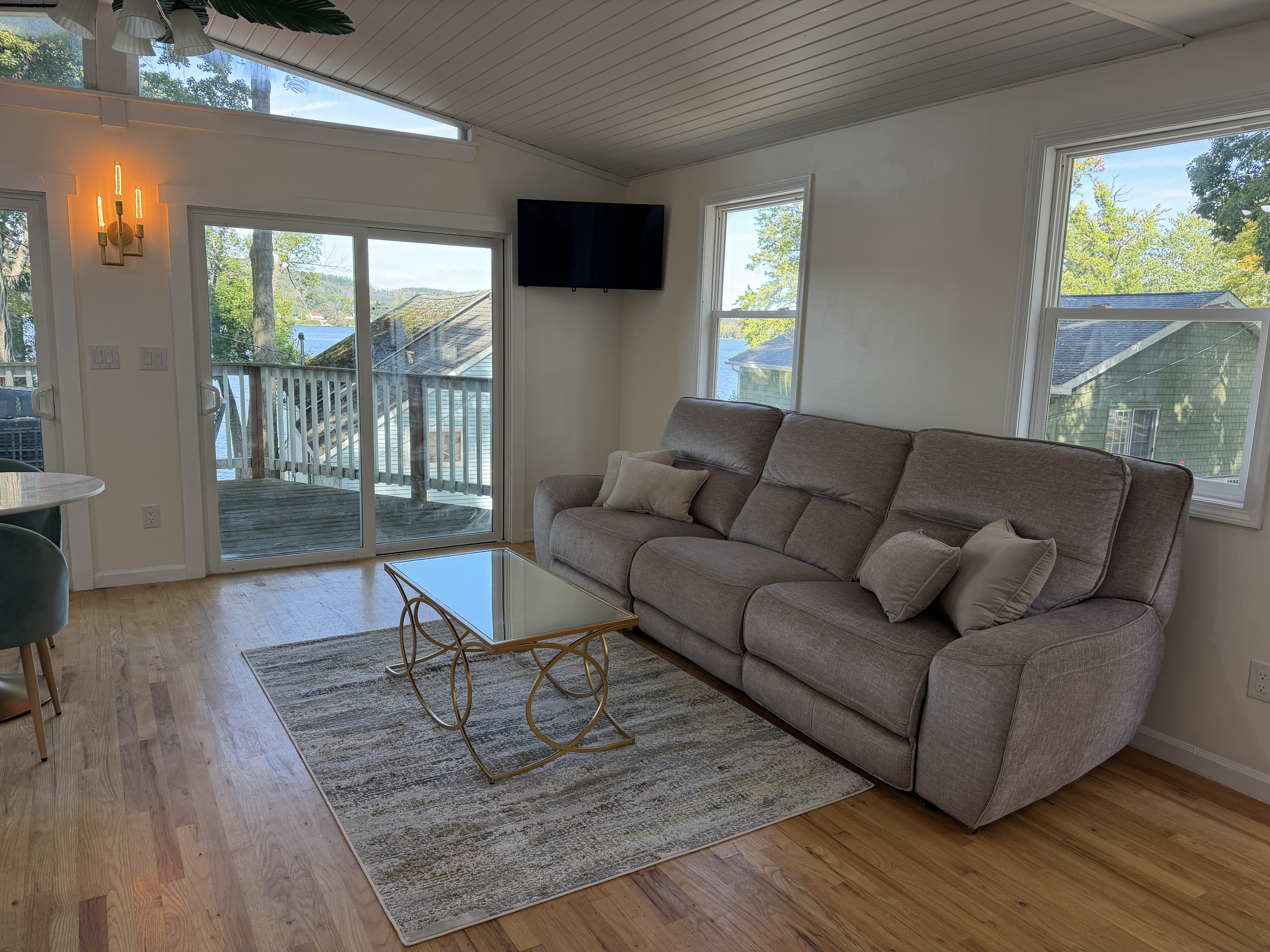 Living room with sliders to deck and SmartTV