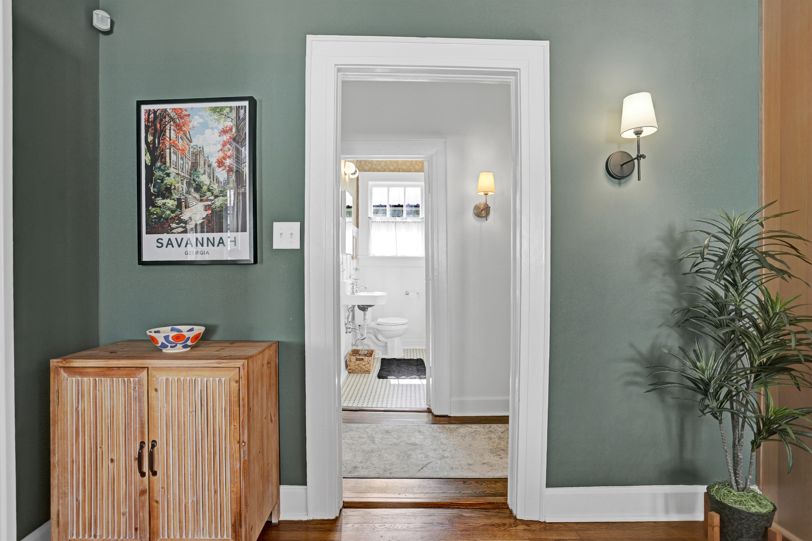 Thoughtfully curated artwork and lighting create a warm, inviting passage through the home.