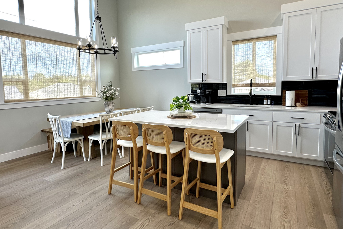 Dining table and island seating side by side, so the whole group eats in one place and the cook is never left out.