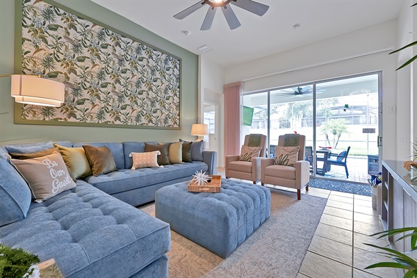 Relax in style — bright, cozy living room with pool view.