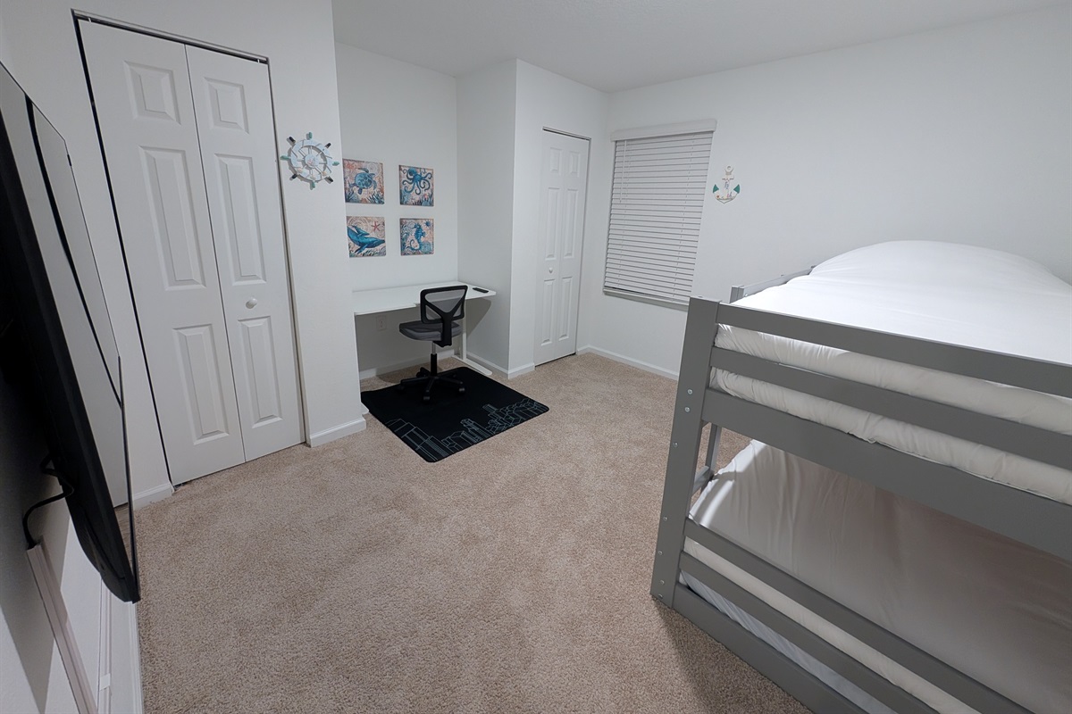Kid room with 2 bunk beds, and a work desk for work at home