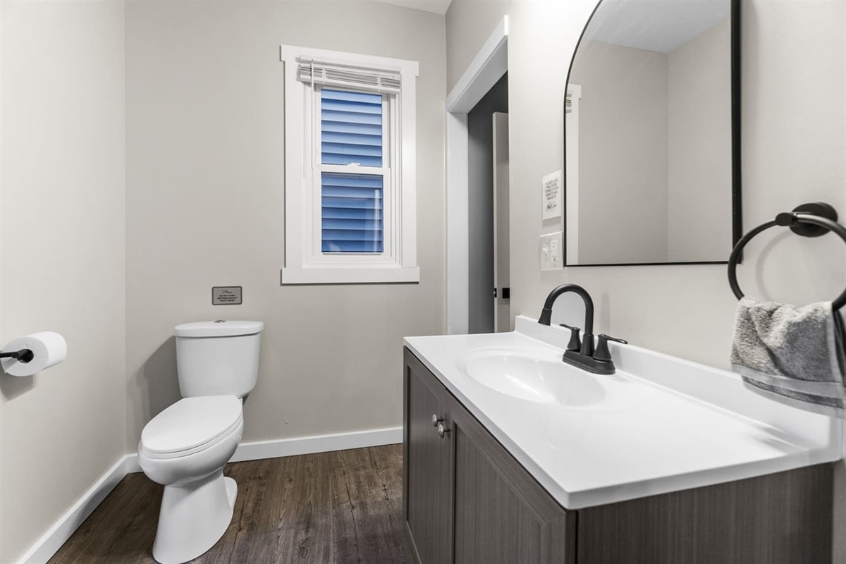 Stylish modern bathroom featuring a sleek vanity and contemporary design elements.