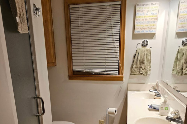 Bathroom with 2 sinks, shower, and toilet