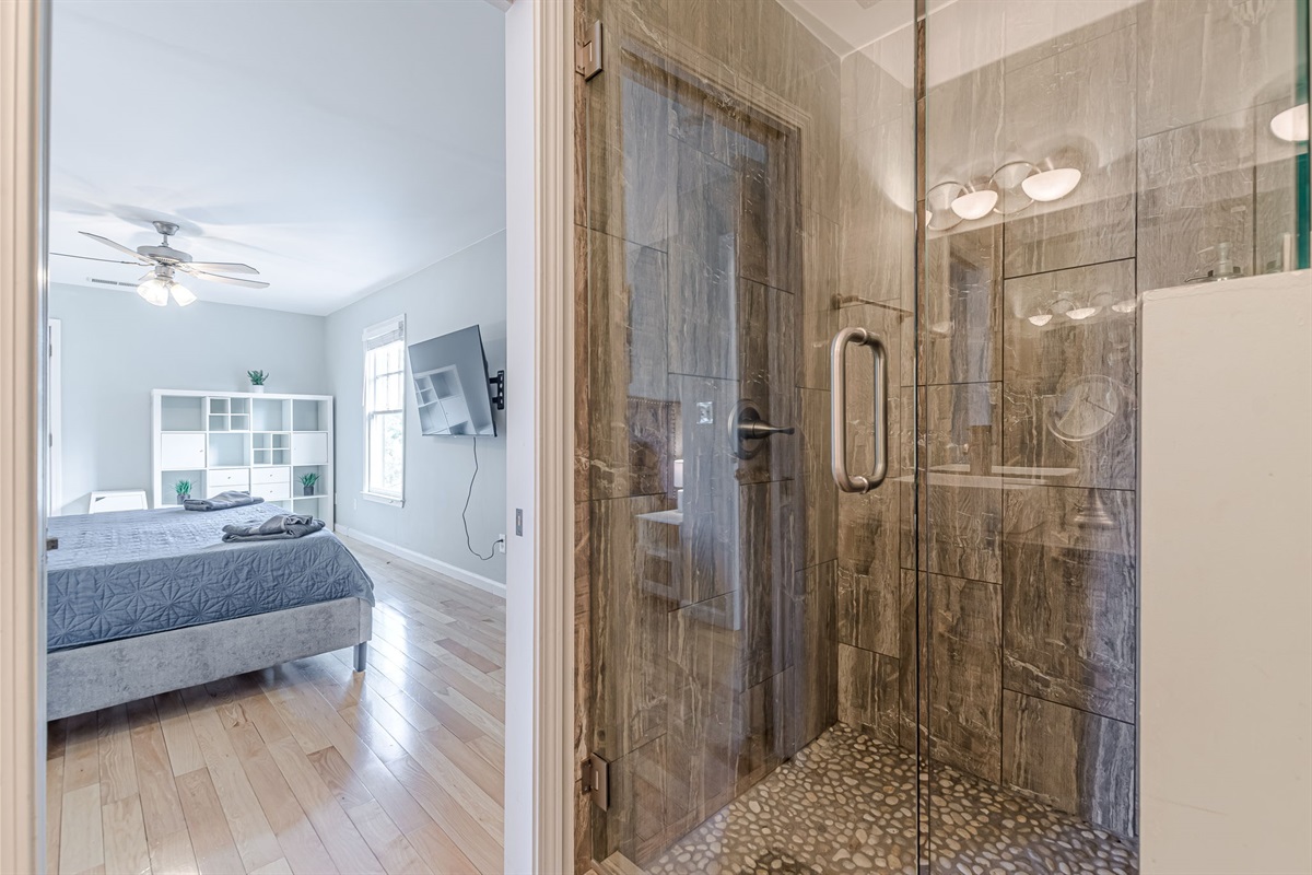 Indulge in a spa-like experience with a large walk-in shower and rainfall showerhead.