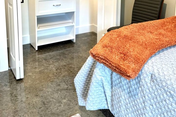 Lighted closet with a closet organizer to store or hang all your clothes. Extra pillows and blankets as well as a chair for sitting down to put your shoes on when getting dressed.