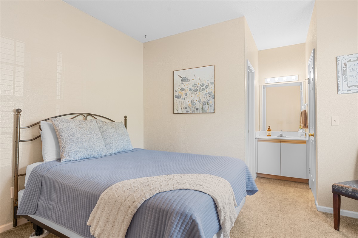 Another view of the second bedroom, showing the easy layout and attached bath access.