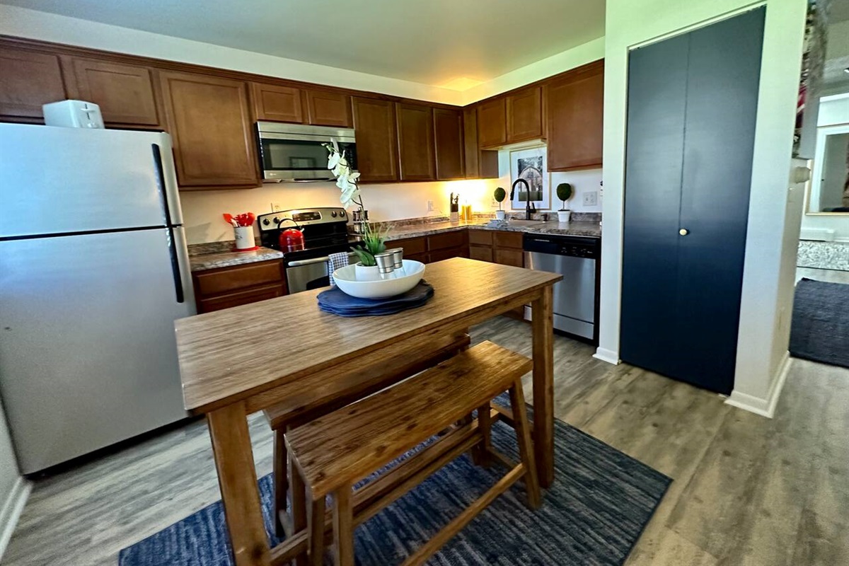 Enjoy meals or morning coffee at this  bistro table in a fully equipped kitchen featuring SSl appliances, ample counter space, and charming decor. Whether you're cooking in or dining out, this kitchen has everything you need for a great stay.