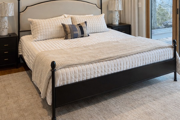 The primary suite on the main floor has an ensuite bathroom with access to a private deck to enjoy the lakefront.