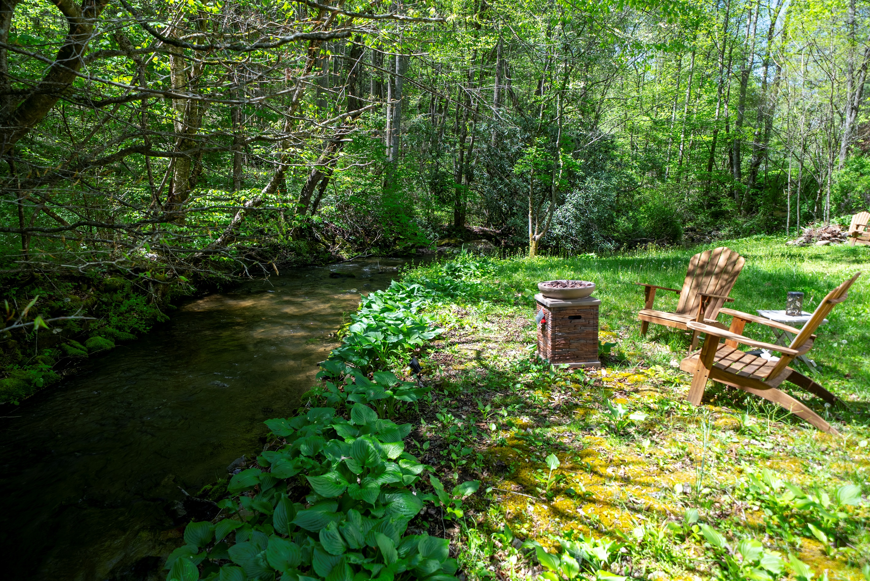 Enjoy effortless evenings by the creek with a convenient propane fire pit- just turn it on and relax.