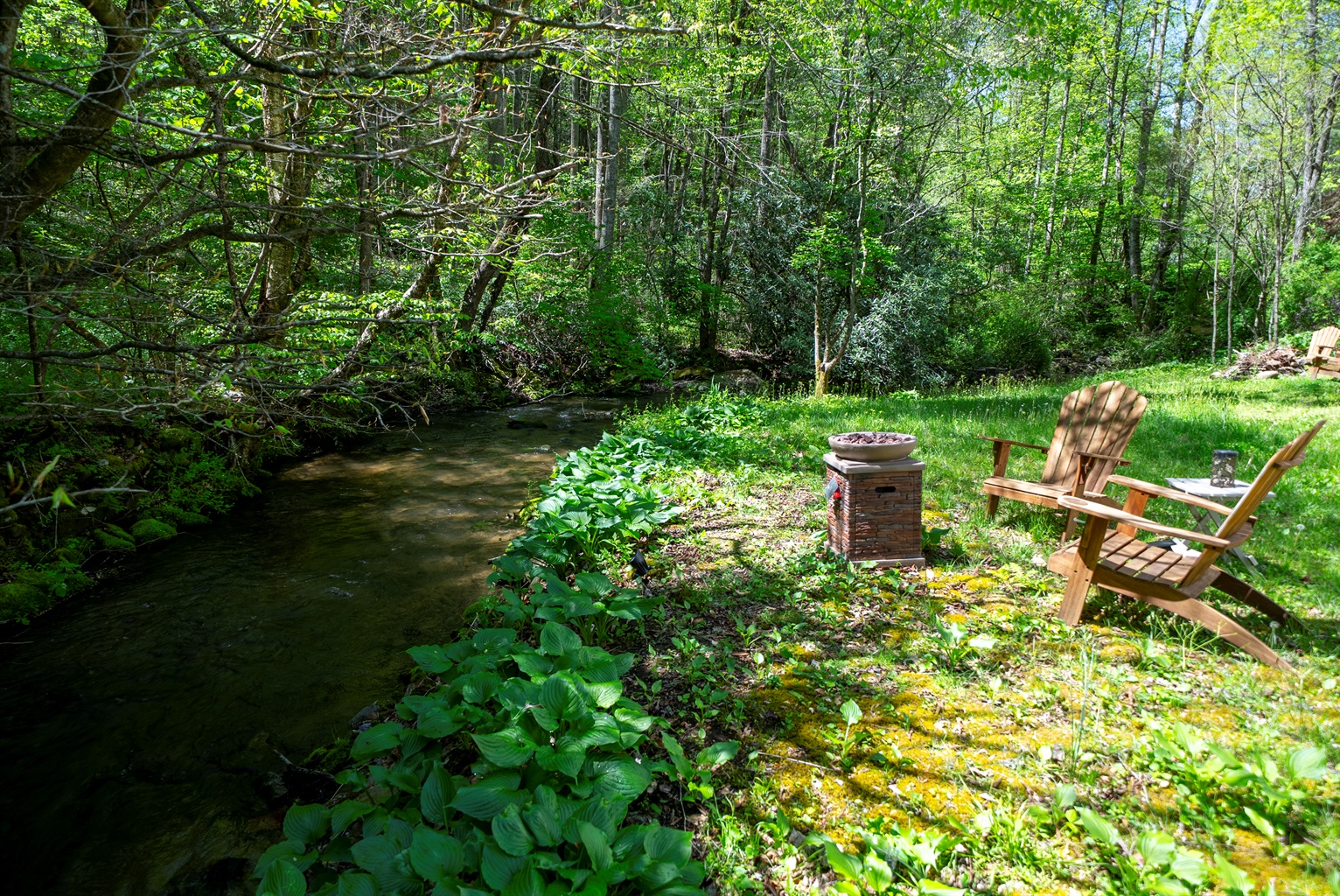 Enjoy effortless evenings by the creek with a convenient propane fire pit- just turn it on and relax.