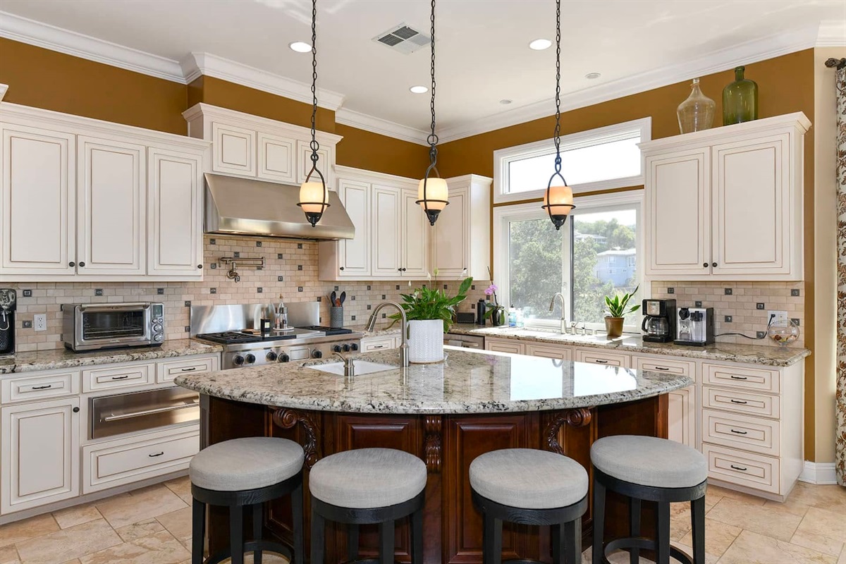 Fully stocked kitchen with 4 person dining table and 4 person kitchen island seating.