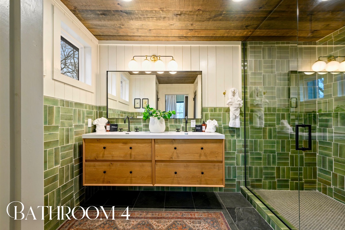 A beautifully tiled walk-in shower and modern vanity make this bathroom both stylish and functional.