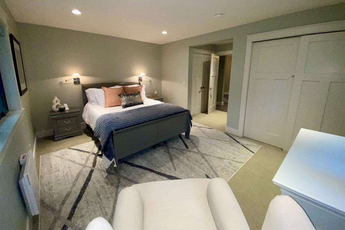 The second Primary bedroom features a comfortable Queen bed perfect for a relaxing morning to stay and snuggle under the covers.