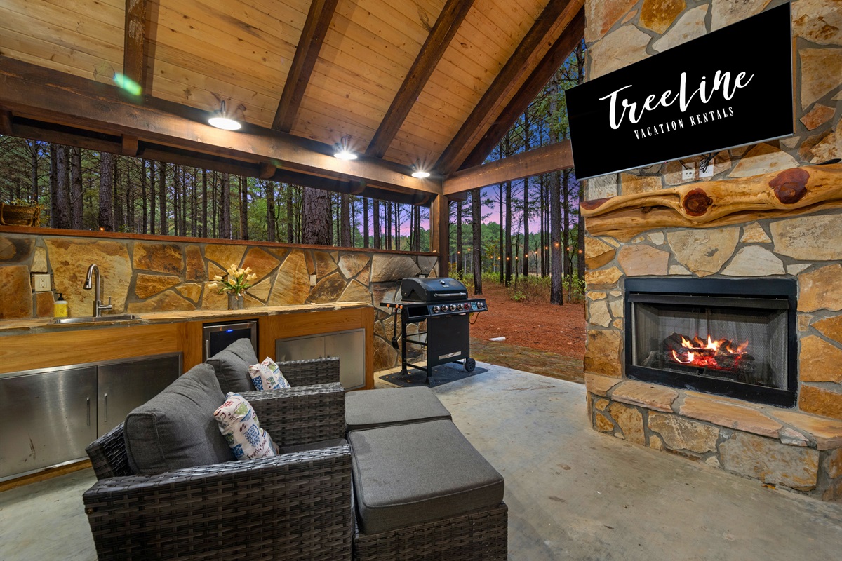 Covered patio with fireplace and TV for year-round enjoyment.